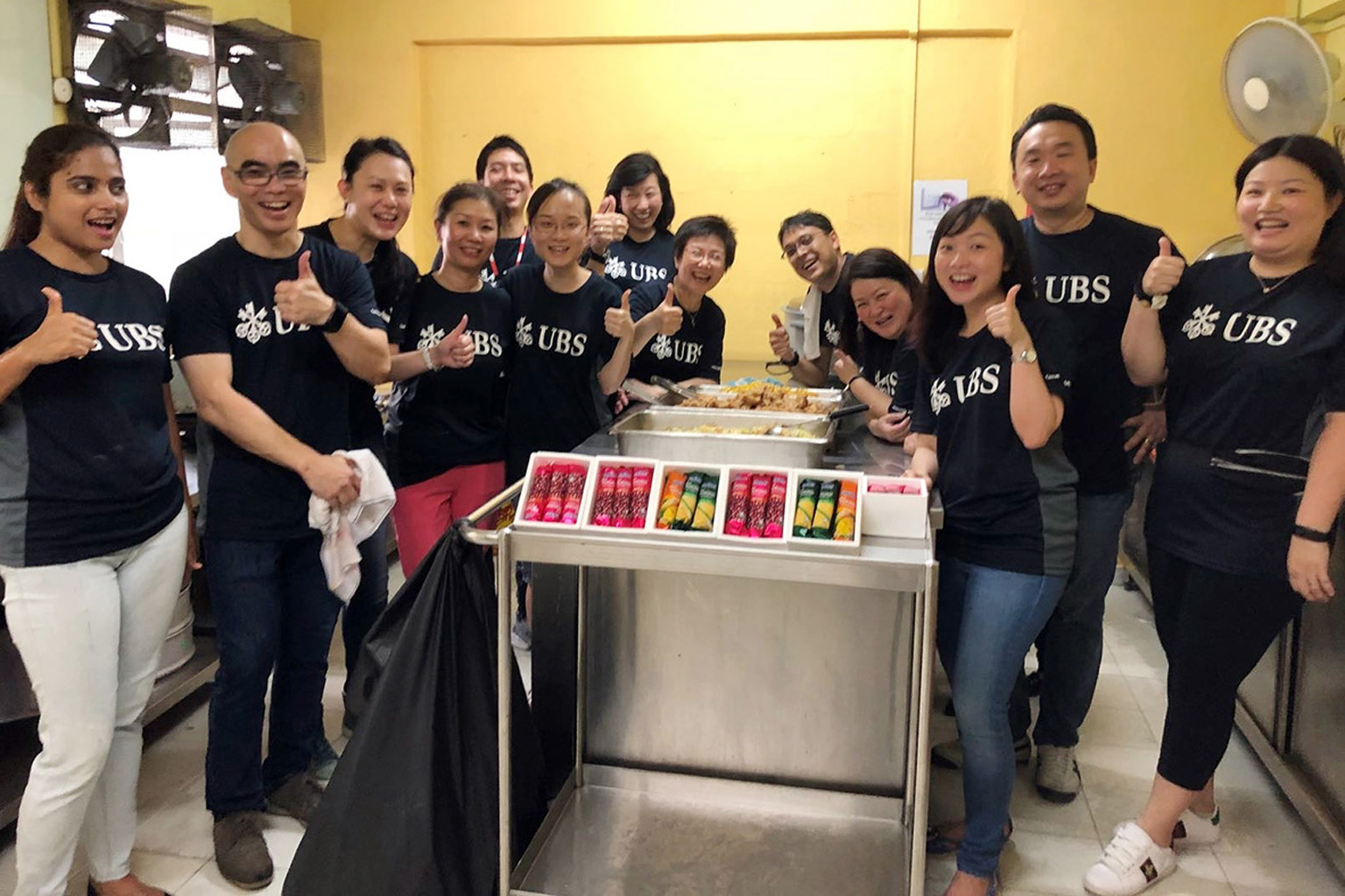 UBS Singapore volunteers at a charity event. The bank's staff contributed to the sum donated to the ST School Pocket Money Fund, which helps children from low-income families with their schooling needs.