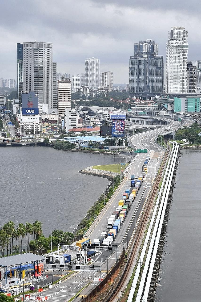 The Causeway linking Singapore and Malaysia in April. The two countries' green lane arrangement offers an important test case of how countries can successfully lift curbs while keeping Covid-19 in check, say the writers.