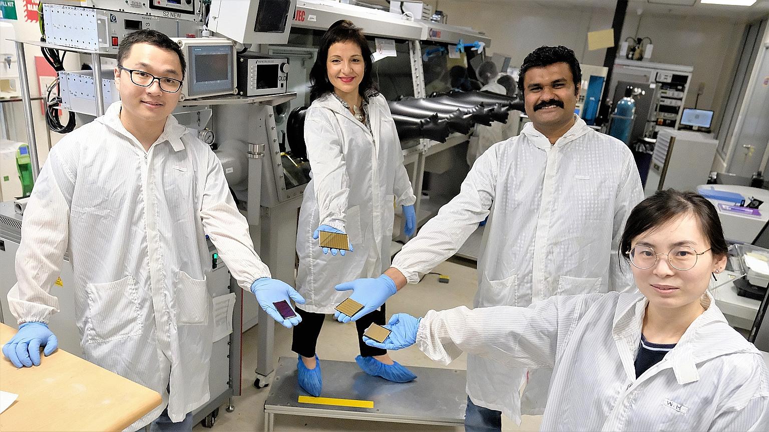 (From left) Dr Li Jia, Dr Annalisa Bruno, Associate Professor Nripan Mathews and Dr Wang Hao with the 21 sq cm perovskite solar cell modules created by their team at Nanyang Technological University. Using an industrial technique to form the perovski