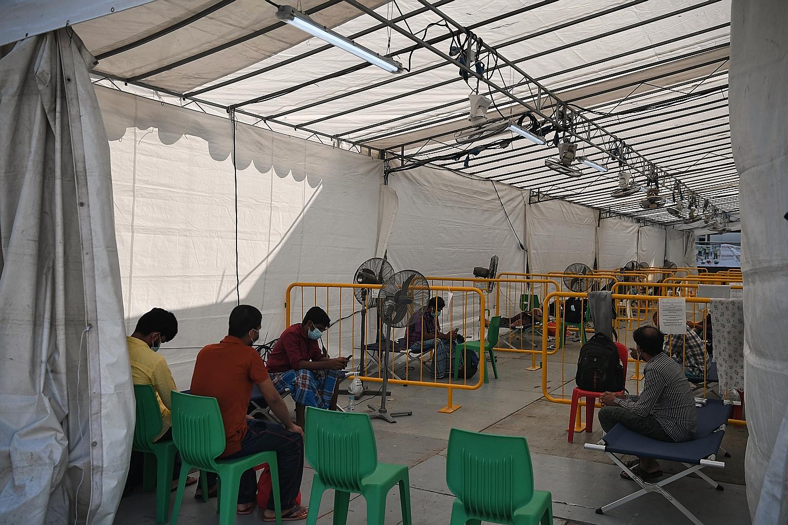 Workers at a swab isolation facility in May. About 94 per cent of Singapore's confirmed Covid-19 cases are dorm residents. ST PHOTO: KUA CHEE SIONG
