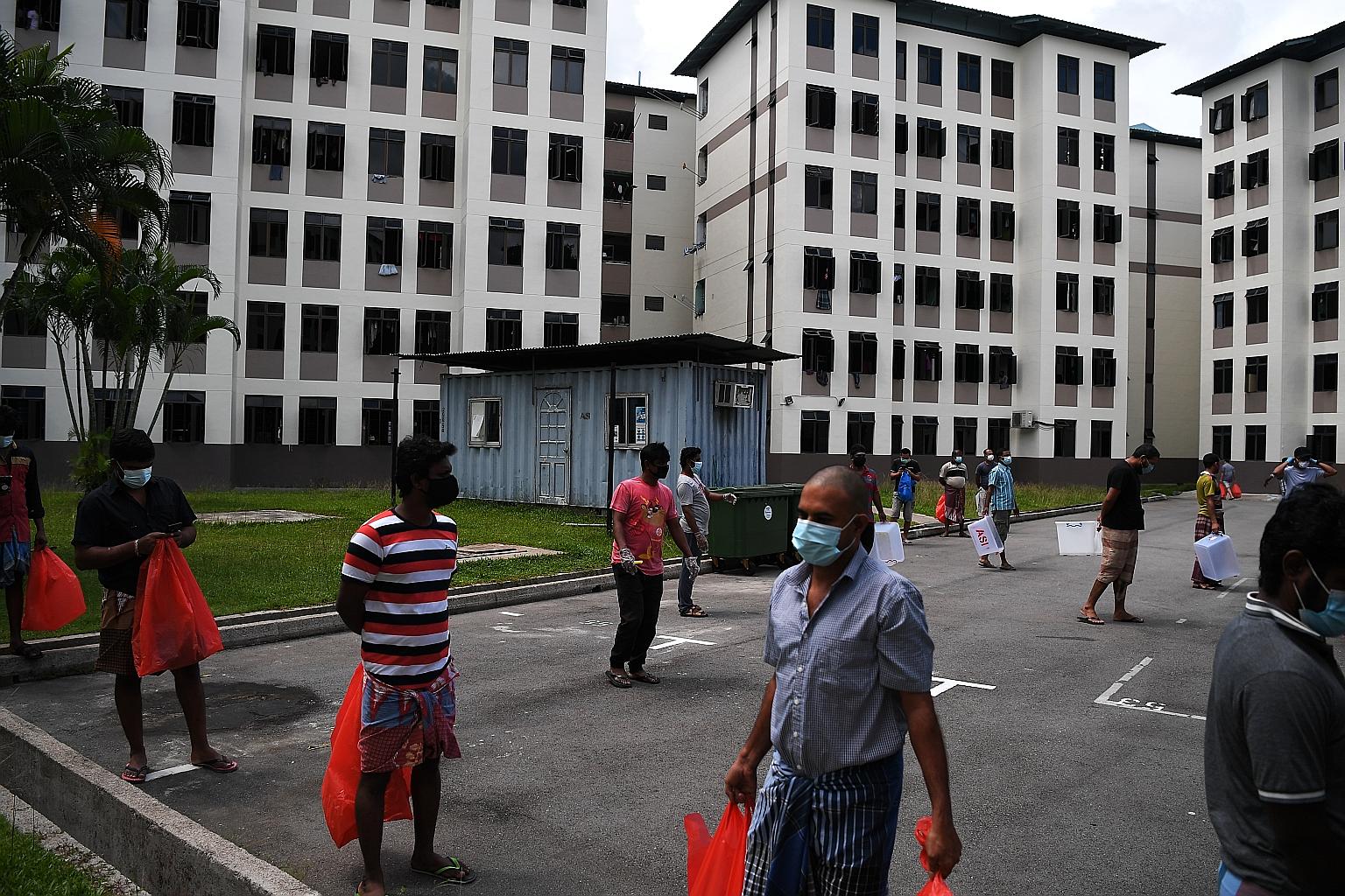 Dormitory residents observing safe distancing while waiting to collect their lunch early last month. For the final phase of testing, many workers come from dorms with higher prevalence of virus cases. This is why there has been a rise in confirmed ca