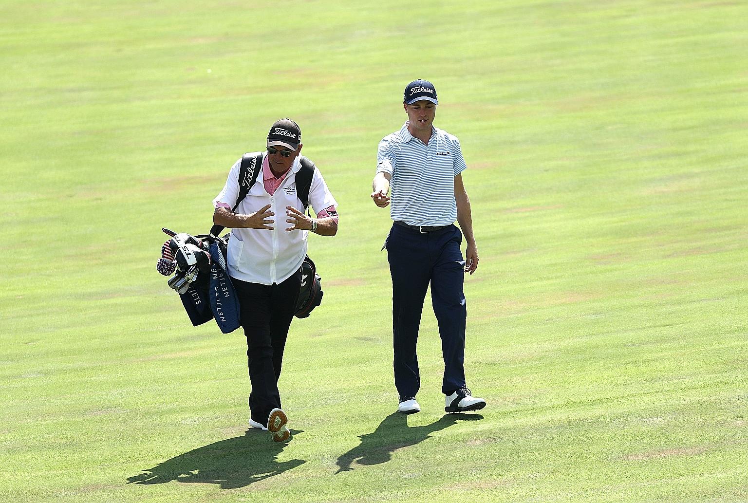 American Justin Thomas and his father Mike walking on the 17th hole during the third round of the Memorial. Mike, who is the world No. 3's swing coach, doubled up as caddie when usual bagman Jimmy Johnson fell ill. He also stepped in for Johnson in 2