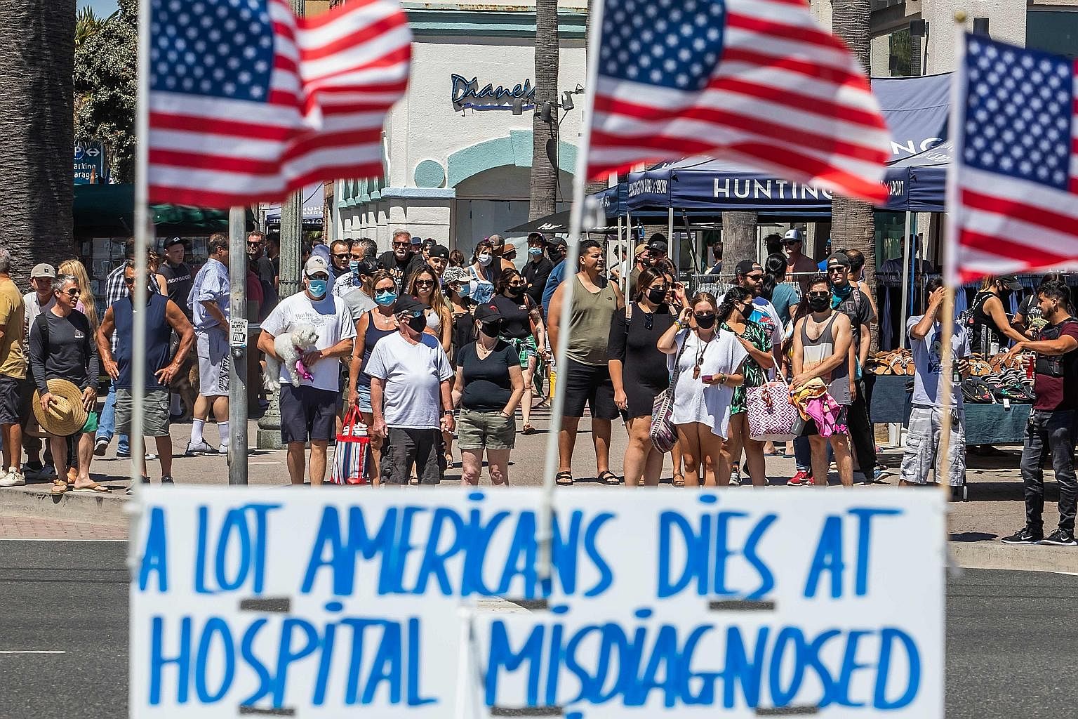 A sign protesting against the healthcare system, in Huntington Beach, California, on Sunday. After the US government committed US$3 trillion (S$4.2 trillion) to support the economy through curbs in April and May, the virus is surging to record levels