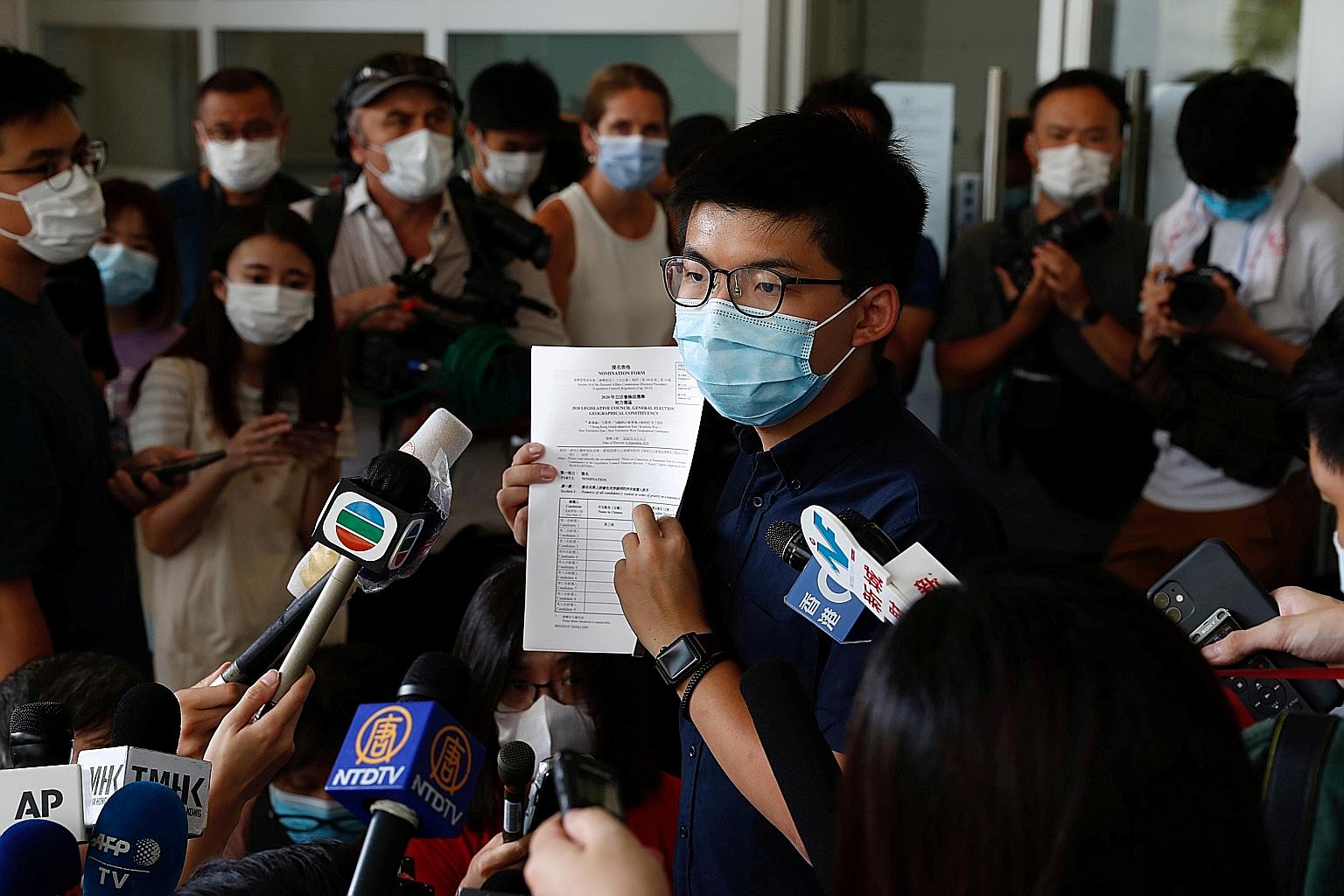 Pro-democracy activist Joshua Wong registered as a candidate for the upcoming Legislative Council election in Hong Kong yesterday, raising the prospect of a battle with the authorities after being barred from running in previous polls. PHOTO: REUTERS