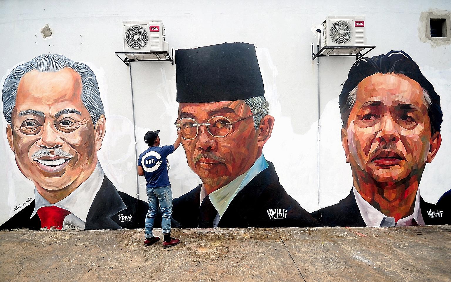 Murals on the walls of a housing estate in Selangor, depicting Malaysian leaders such as (from far left) Prime Minister Muhyiddin Yassin, the Malaysian King and Health Ministry director-general Noor Hisham Abdullah, were found vandalised yesterday. C