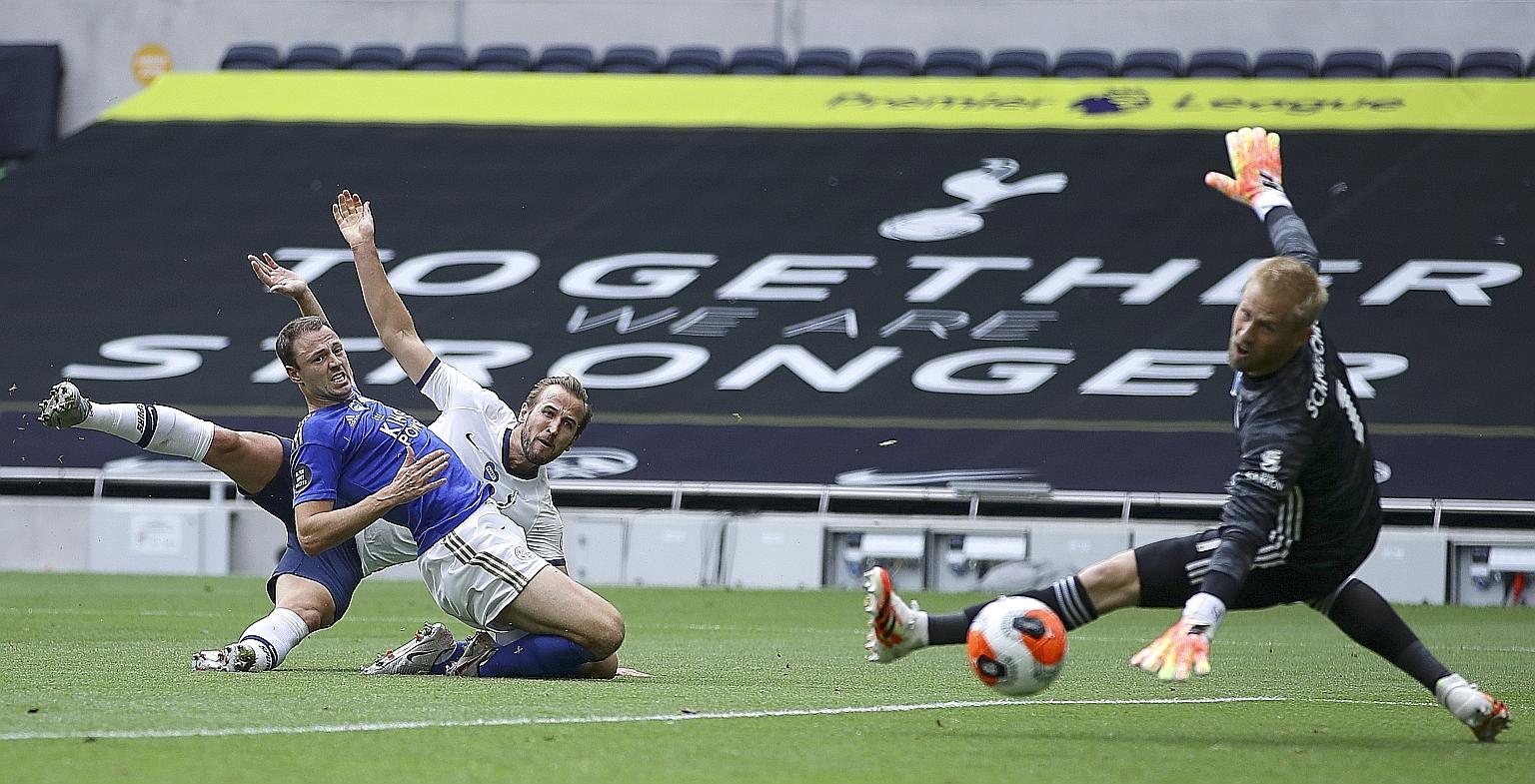 Harry Kane scoring past Leicester goalkeeper Kasper Schmeichel to put Tottenham 2-0 up on Sunday. The Foxes are likely to have to beat Manchester United by more than a goal in their final game to make the Champions League. PHOTO: EPA-EFE