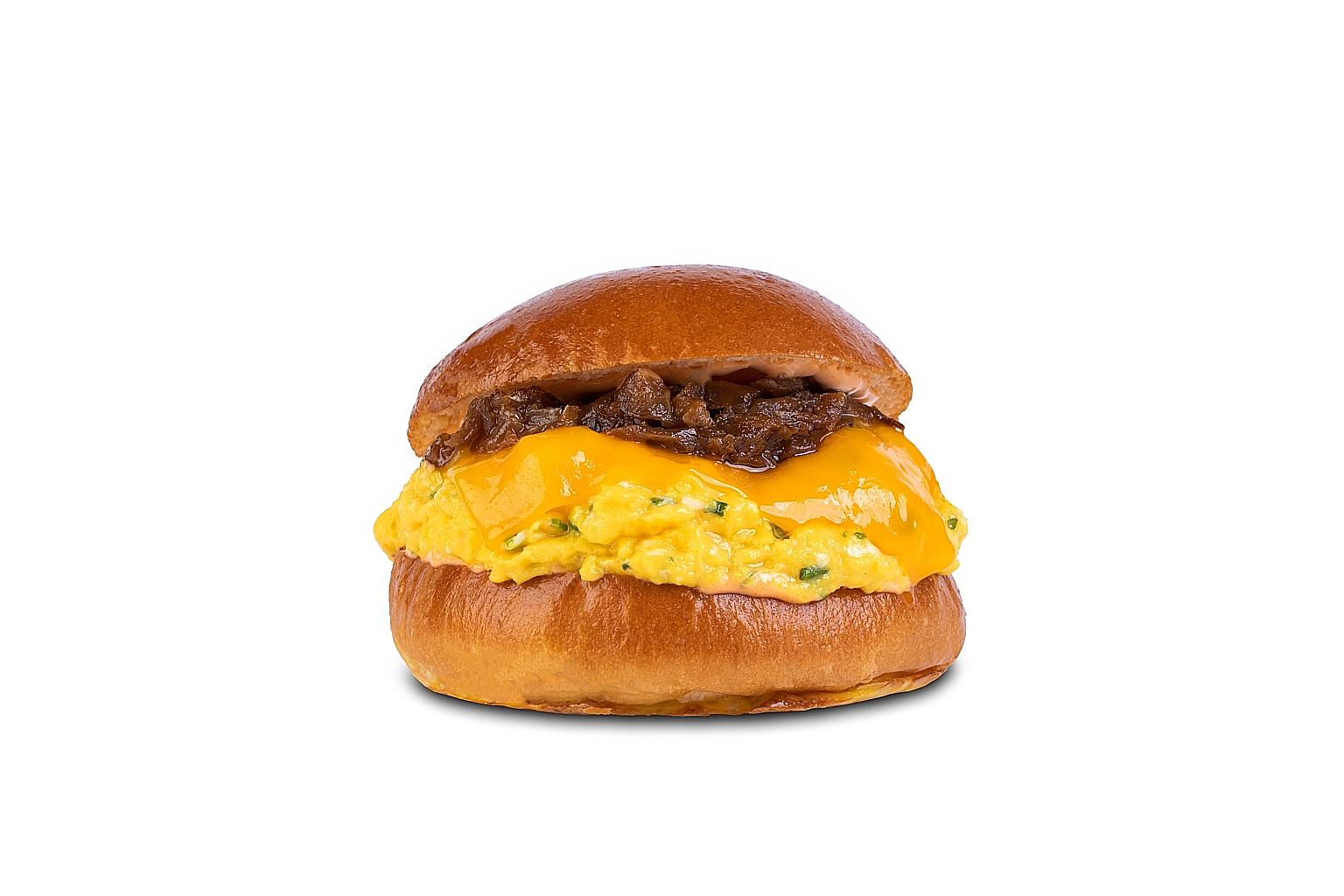 Eggslut's Fairfax burger has scrambled eggs, cheddar cheese and spicy sriracha mayonnaise between two halves of a brioche bun.