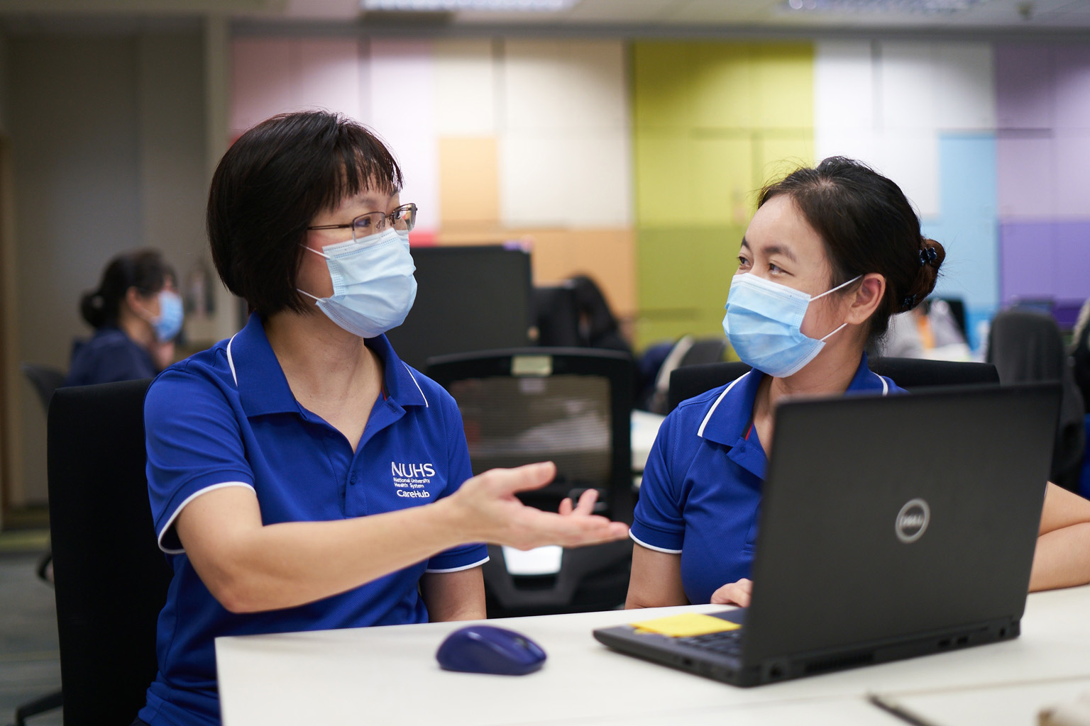 Ms Tay Yee Kian (left), assistant director of nursing at NUHS' Regional Health System Office, seen here with her colleague Yeo Ai Wah, led her team to supervise the set-up for Covid-19 swab testing at 15 nursing homes.