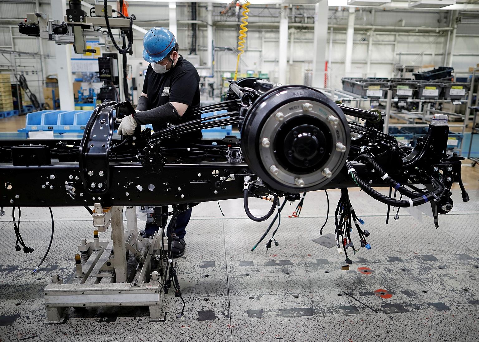 An employee working on the assembly line at the Kawasaki factory of Mitsubishi Fuso Truck and Bus Corp in Kawasaki, south of Tokyo, in May. Japan's economy is forecast to shrink 5.3 per cent this fiscal year.