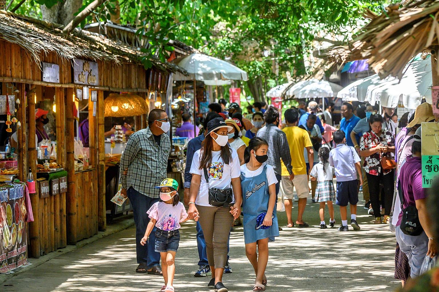 Local tourists at a market outside Ayutthaya, north of Bangkok, last Saturday. Over the past two months, Bangkok has lifted its night curfew and eased curbs on inter-provincial travel to aid its economy.
