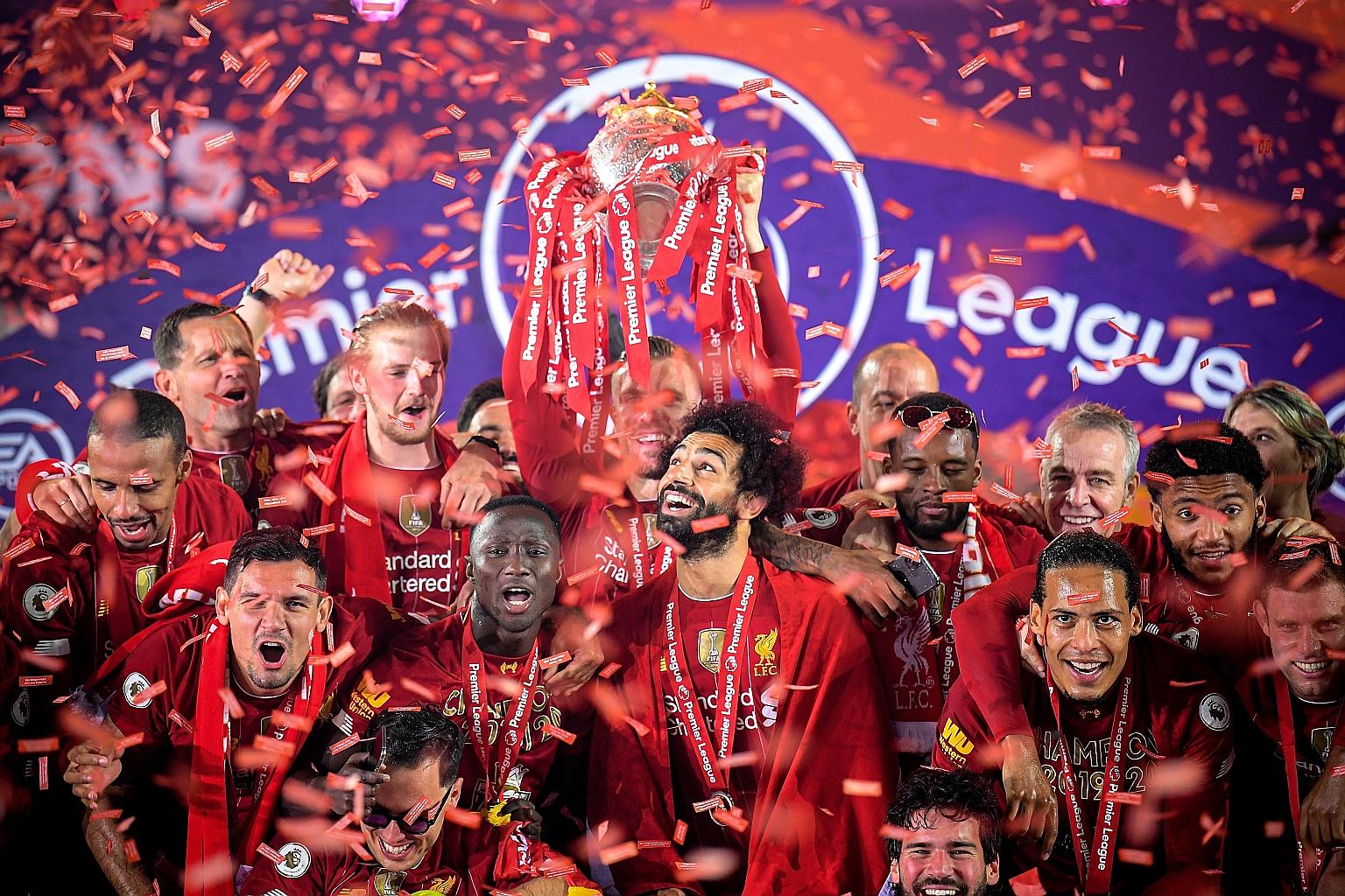 Liverpool captain Jordan Henderson lifting the Premier League trophy after his team's win against Chelsea at Anfield on Wednesday.