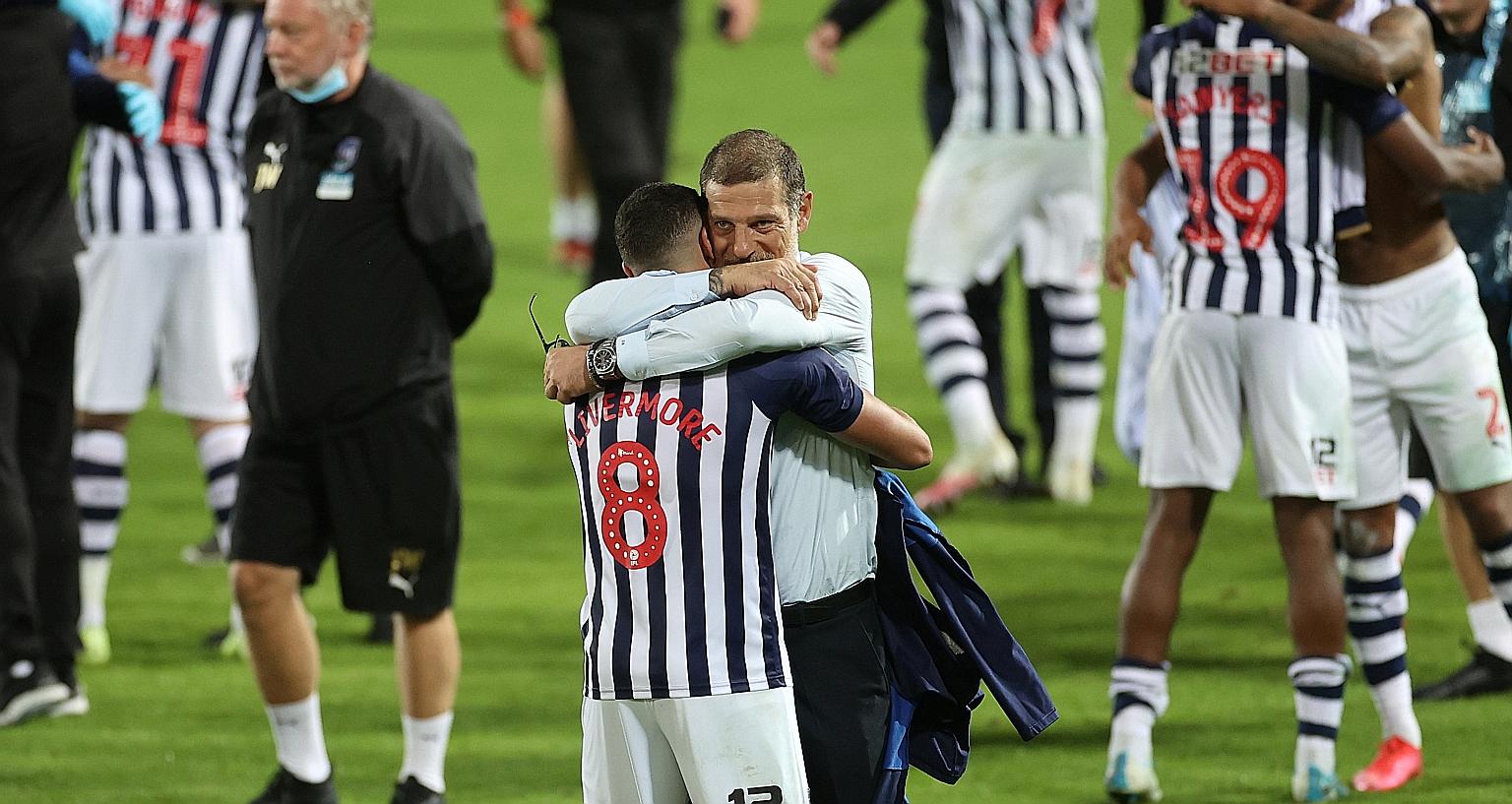 West Brom manager Slaven Bilic hugging Jake Livermore after an emotional 2-2 draw with Queen's Park Rangers at the Hawthorns confirmed their promotion to the Premier League on Wednesday.