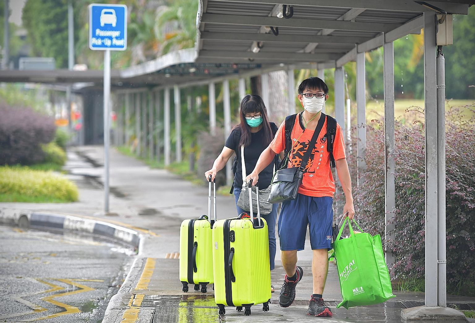 People arriving at Woodlands Checkpoint to make their way to Johor Baru yesterday afternoon. Earlier in the day, pictures of long queues on the Causeway outside the Johor Baru checkpoint were uploaded on social media as Malaysians rushed home ahead o