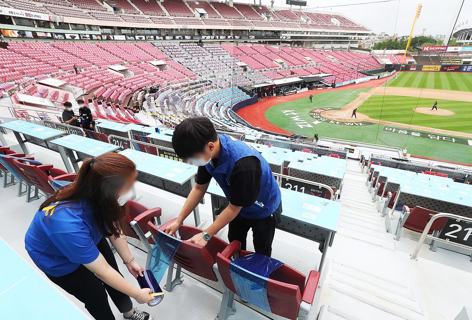Workers preparing for the reopening of KT Wiz Park in Suwon, South Korea. The government has announced that it will allow baseball fans to again attend games in-person at stadiums, starting today. PHOTO: EPA-EFE