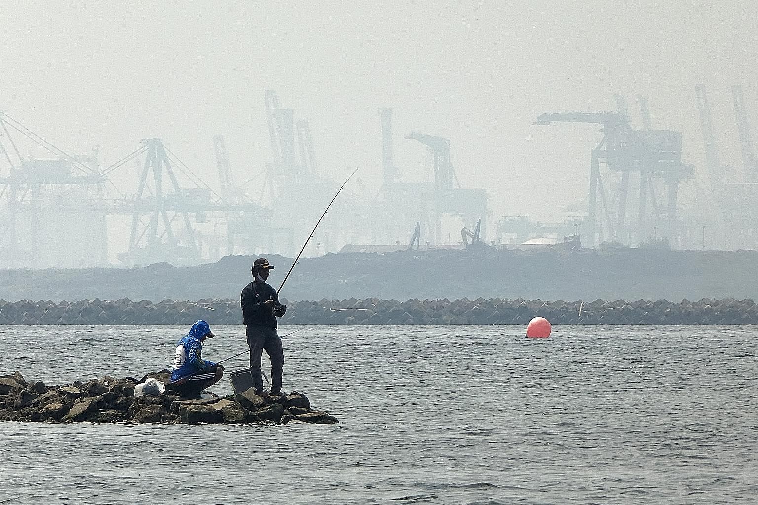 A coastal area of Jakarta shrouded in thick haze last month. If a haze crisis occurs while South-east Asia and the world are still fighting the pandemic, it would compound the strain on public health resources, the writers say, stressing the need to 
