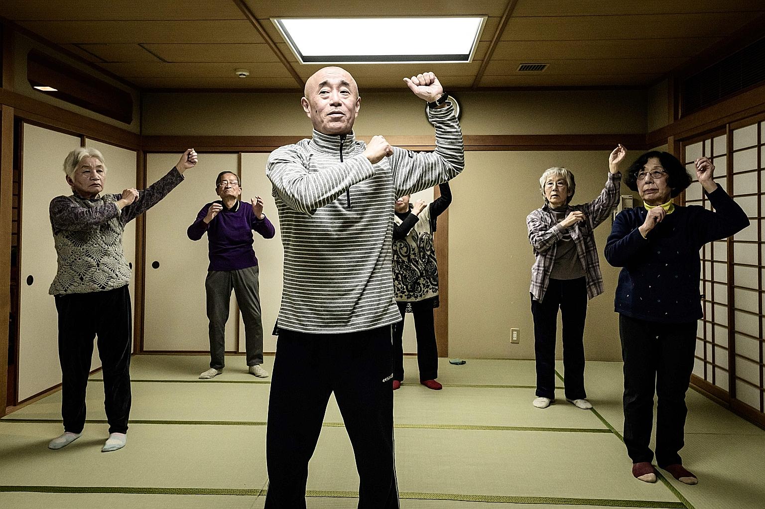 Judo therapist Taisuke Kasuya leading seniors in judo-based exercises at a community centre in Tokyo.