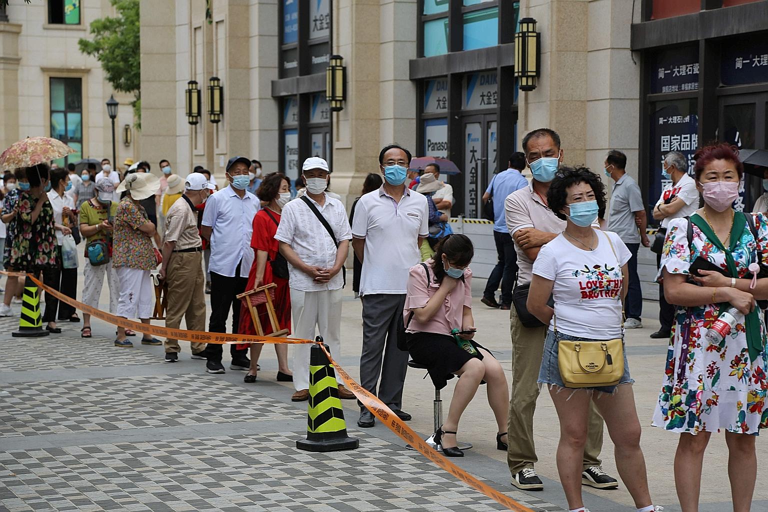 A queue for Covid-19 tests at a makeshift centre in Dalian, Liaoning province, yesterday. Officials said over the weekend that they would begin testing the entire city population of around six million. PHOTO: AGENCE FRANCE-PRESSE
