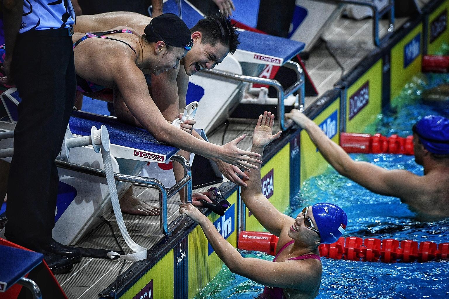 Joseph Schooling and Roanne Ho congratulating Amanda Lim after she anchored the mixed 4x50m medley relay quartet to second place at the 2018 Fina Swimming World Cup.