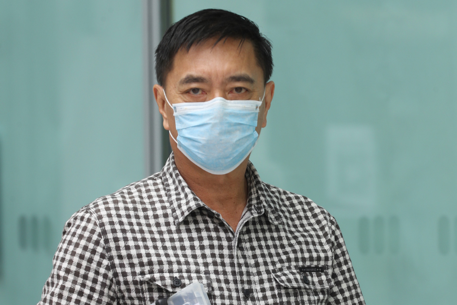 Retired actor-director Ng Aik Leong, better known as Huang Yiliang, is accused of voluntarily causing hurt to his Bangladeshi employee. ST PHOTO: TIMOTHY DAVID