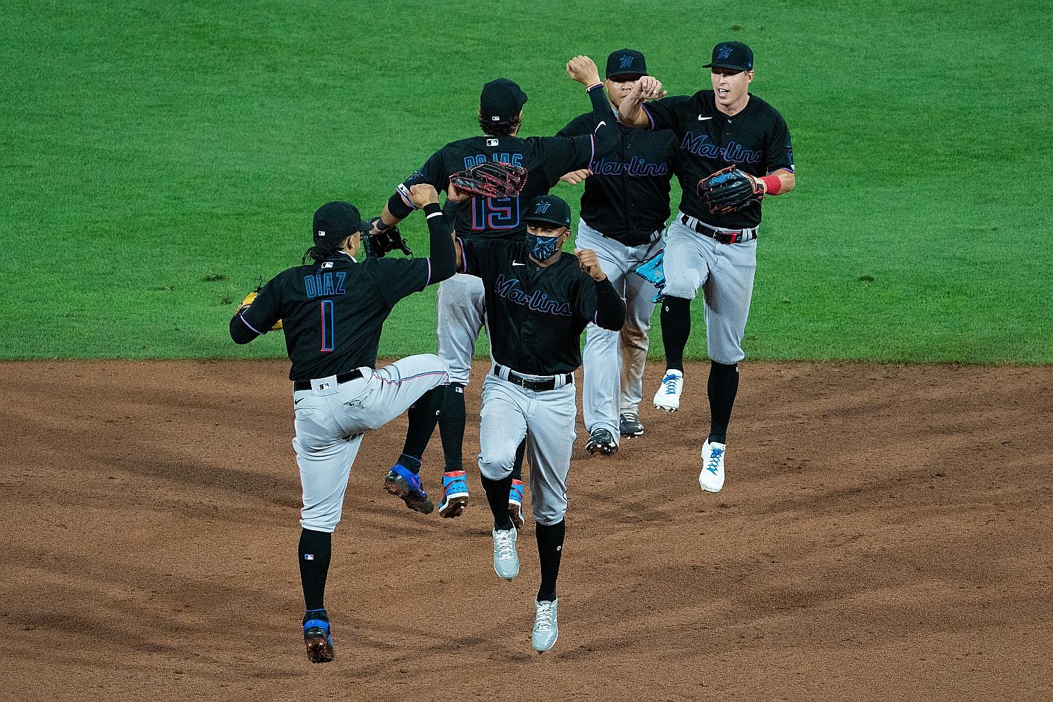 The Miami Marlins celebrate a season-opening win over the Philadelphia Phillies. Miami's season has been derailed after multiple players tested positive for the coronavirus after the game.