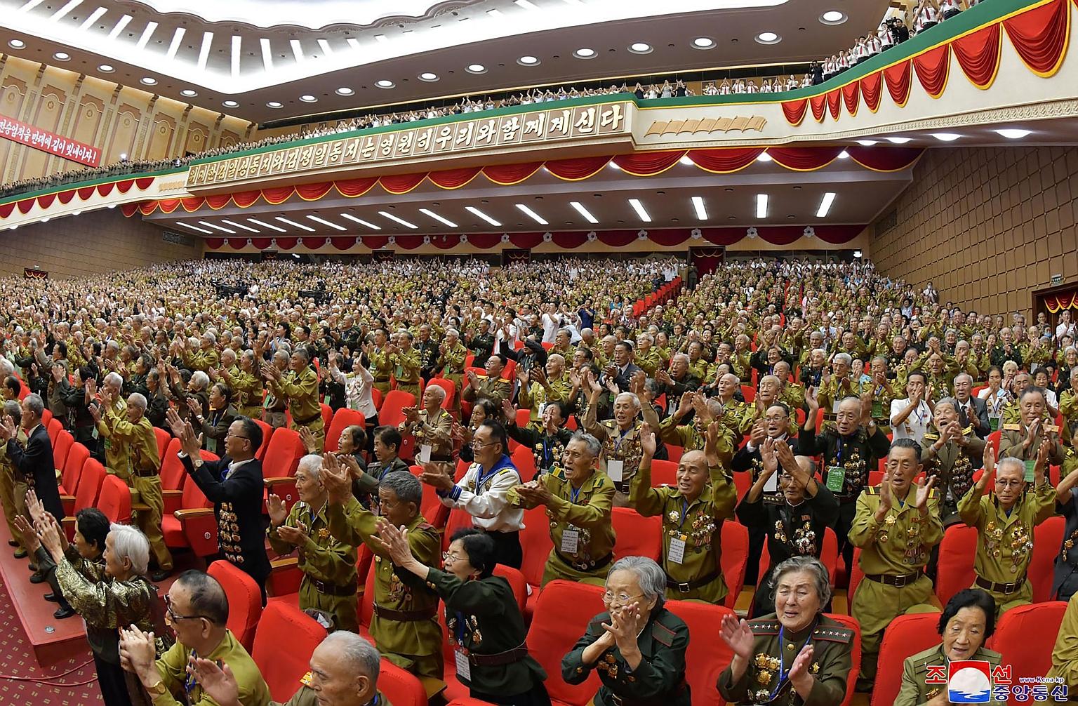 Attendees cheering at the 6th National Conference of War Veterans at the April 25 House of Culture in Pyongyang on Monday. PHOTO: AGENCE FRANCE-PRESSE