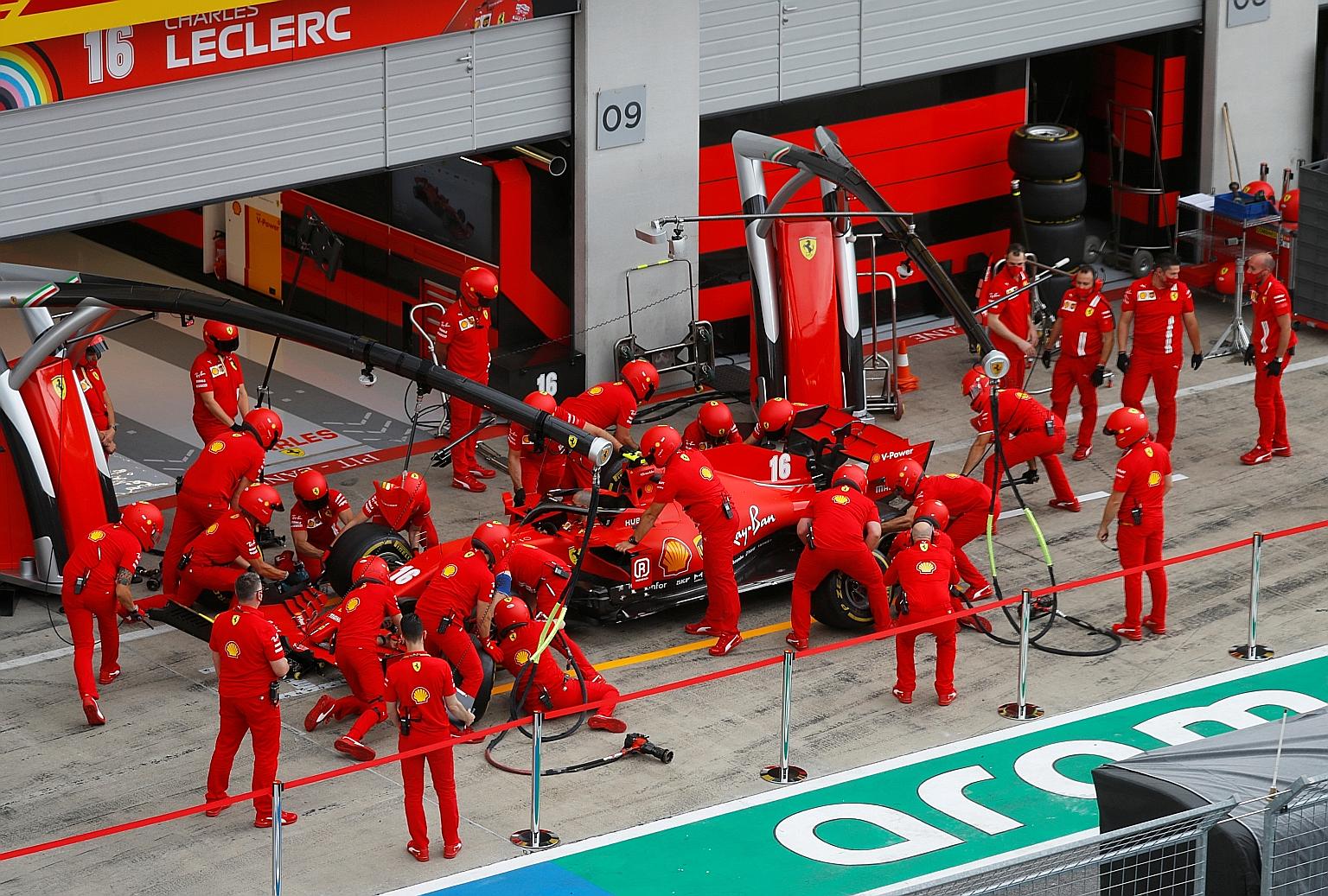 Ferrari mechanics practising a pit stop routine at the Austrian Grand Prix. Their car has been criticised for its speed on the track, earning just one podium this year.