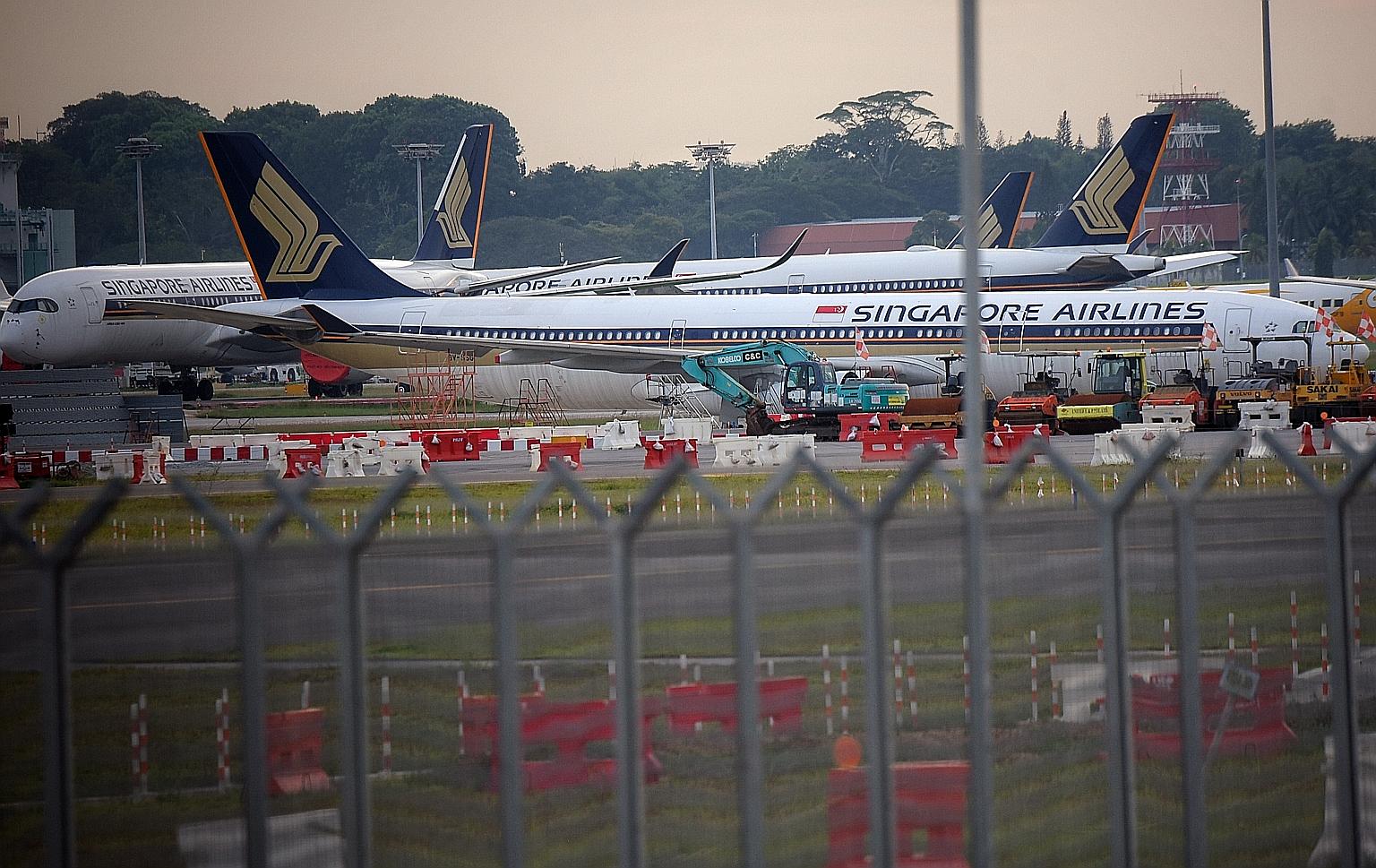 Singapore Airlines planes parked on the tarmac of Changi Airport last month as air travel demand evaporated amid travel restrictions and border controls imposed around the world to contain the spread of the coronavirus.