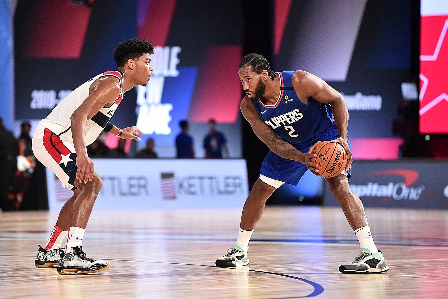Los Angeles Clippers' Kawhi Leonard, facing Jerome Robinson of Washington Wizards during their NBA scrimmage ahead of the restart of the NBA season. For Leonard, their upcoming games are all about building chemistry among the players after the long l