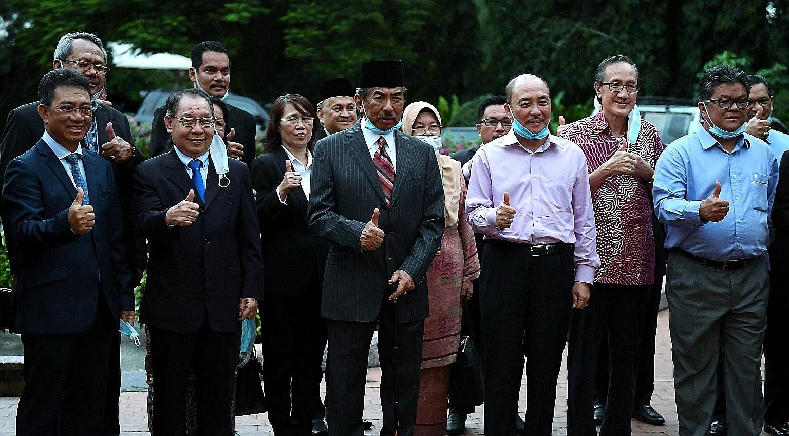 Former Sabah chief minister Musa Aman (centre) with other state assemblymen on the grounds of his house after a media conference on Wednesday. The state polls will represent the first major political battle between the five-month-old Perikatan Nasion