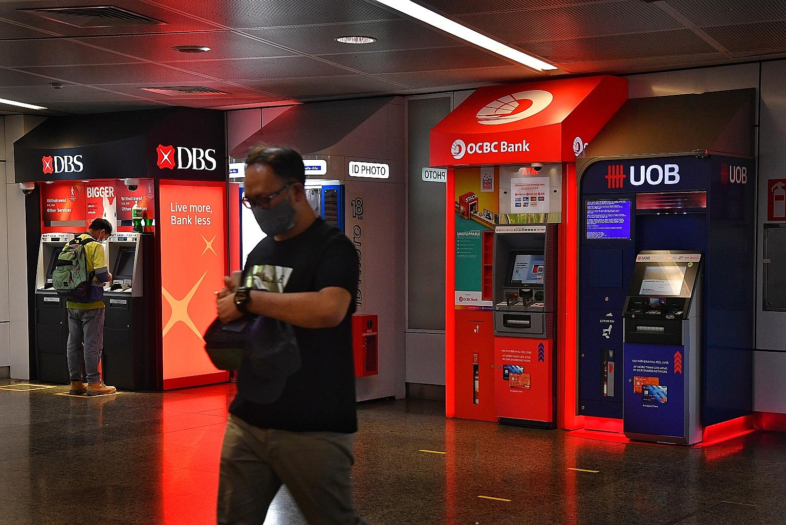 DBS, OCBC and UOB account for nearly 40 per cent of the Straits Times Index, which dropped as much as 2.4 per cent before ending down 1.7 per cent yesterday. ST PHOTO: CHONG JUN LIANG