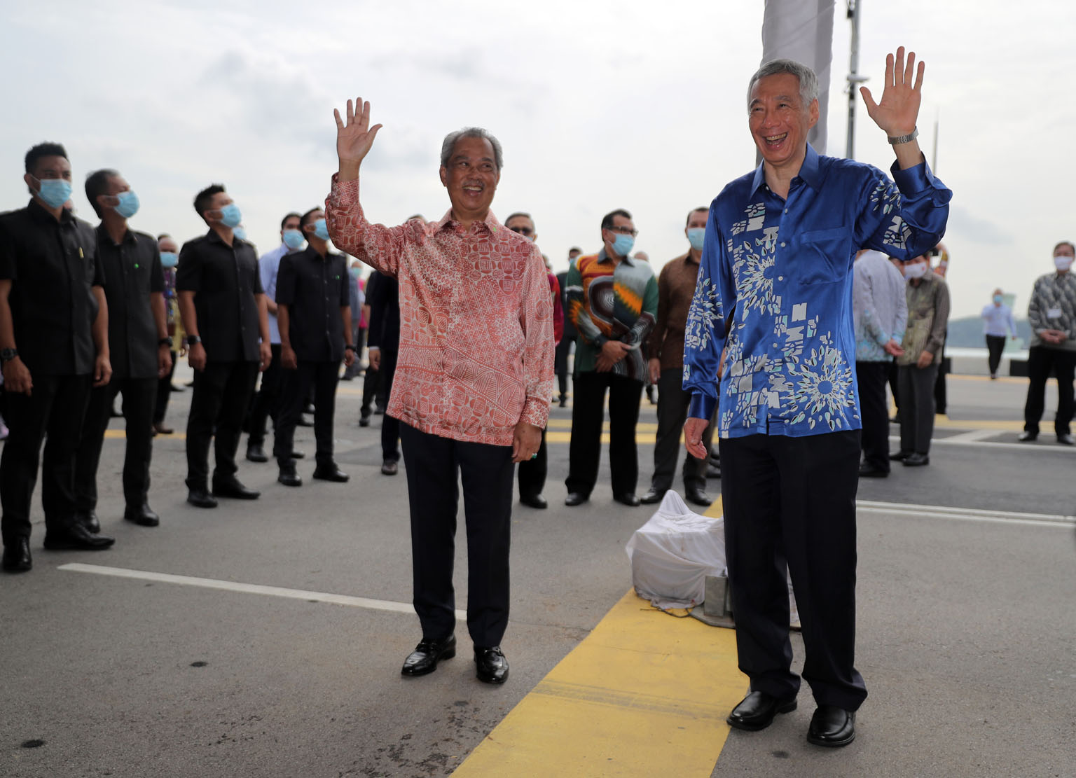 Prime Minister Lee Hsien Loong and Malaysian Premier Muhyiddin Yassin at a ceremony held at the Causeway yesterday to mark the resumption of the RTS Link project. The thick yellow line marks the international boundary. ST PHOTO: GAVIN FOO