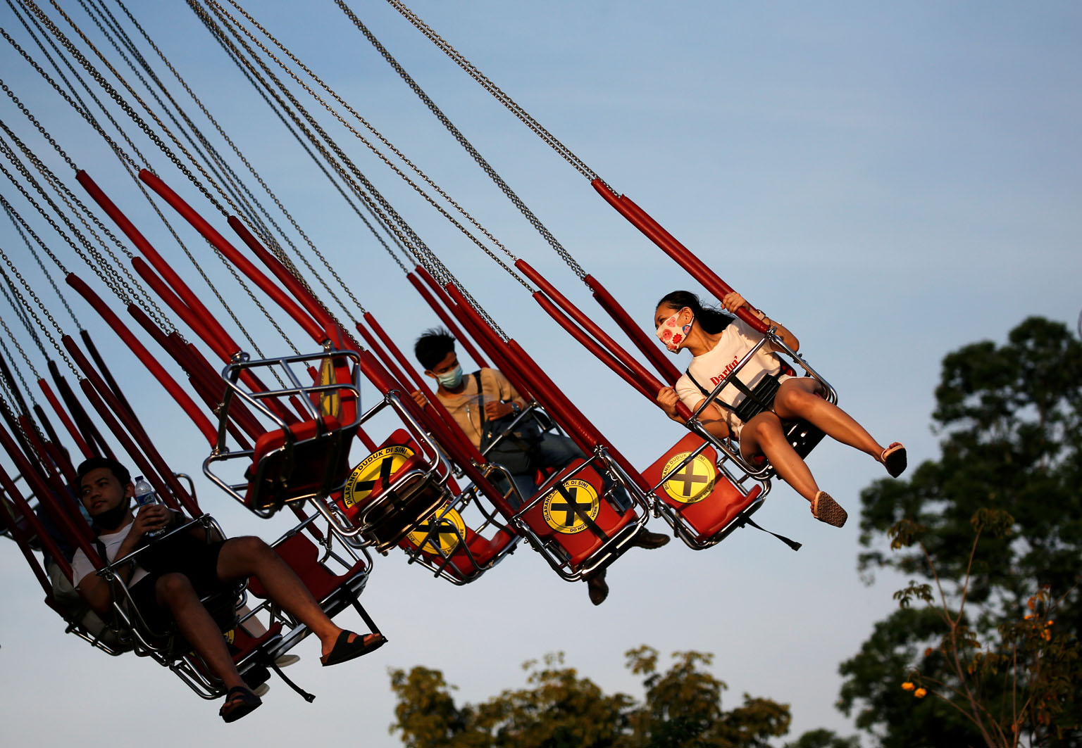 People at Dunia Fantasi amusement park in Jakarta on Sunday. Cities and provinces across Indonesia have gradually eased restrictive measures imposed as part of partial lockdowns. PHOTO: REUTERS