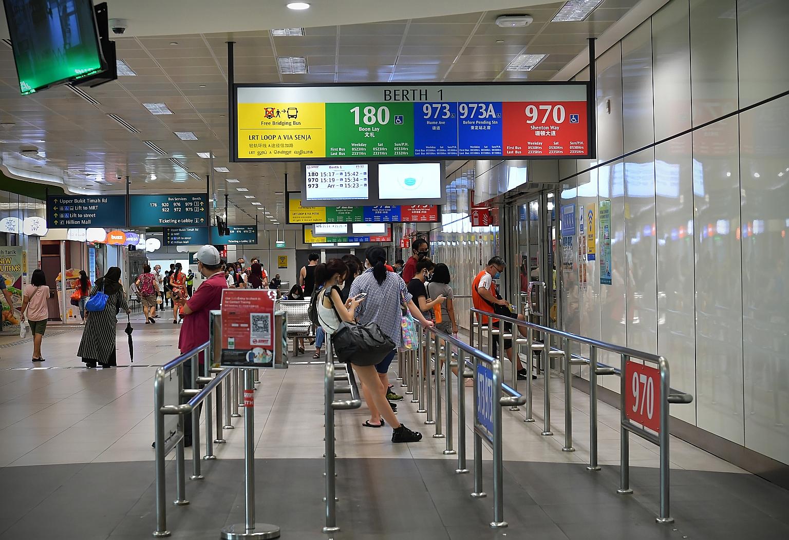 Commuters waiting for buses at the Bukit Panjang Integrated Transport Hub yesterday. Tests showed that the four new cases were likely to have had past infections and are no longer infectious. The two bus drivers and two interchange staff were last at