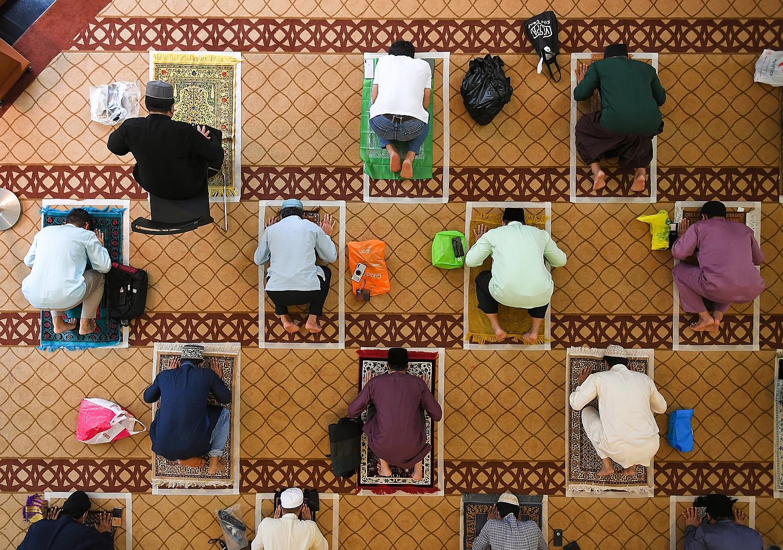 Worshippers at Masjid Maarof in Jurong West yesterday. Most mosques held three sessions with no more than 50 worshippers - who had to book slots online - each time. ST PHOTO: SHINTARO TAY
