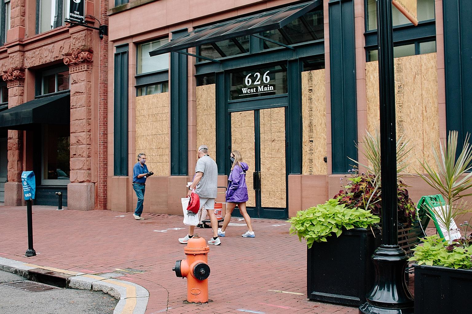 Boarded-up shops in Louisville, Kentucky, last week. The Covid-19 outbreak is moving into Ohio, Kentucky, Tennessee, Missouri, Kansas and Nebraska because of vacations and travels.