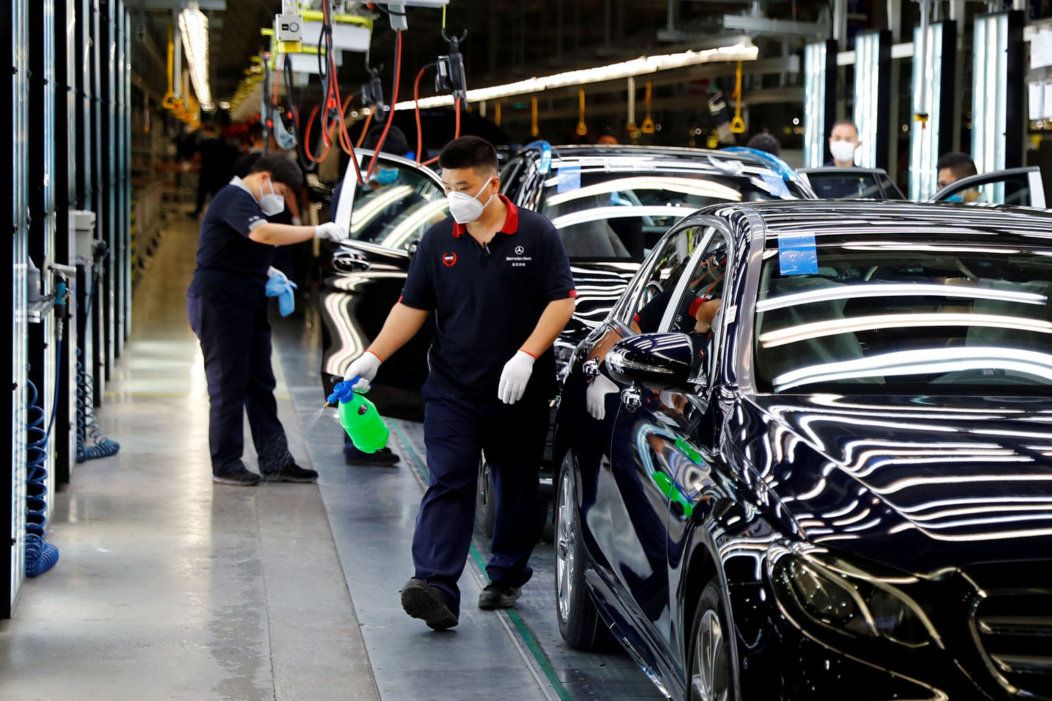 Employees at a plant of the Daimler-BAIC joint venture's Beijing Benz Automotive in Beijing in May. Despite better PMI readings, analysts caution that the recovery could stall amid rising global Covid-19 infections and as China's factories deal with