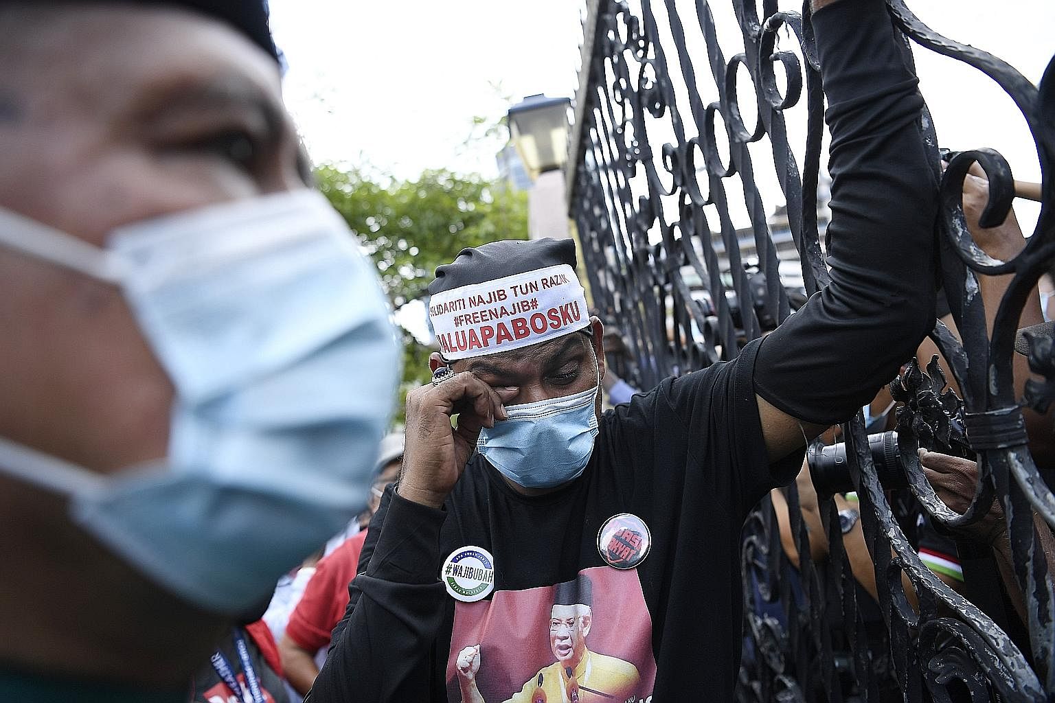 A Najib supporter reacting to the news of the court ruling on Tuesday. Hundreds had crowded the High Court compound to support the former premier. Though Najib still faces another four criminal trials, he remains a popular figure in Malaysia, with hi
