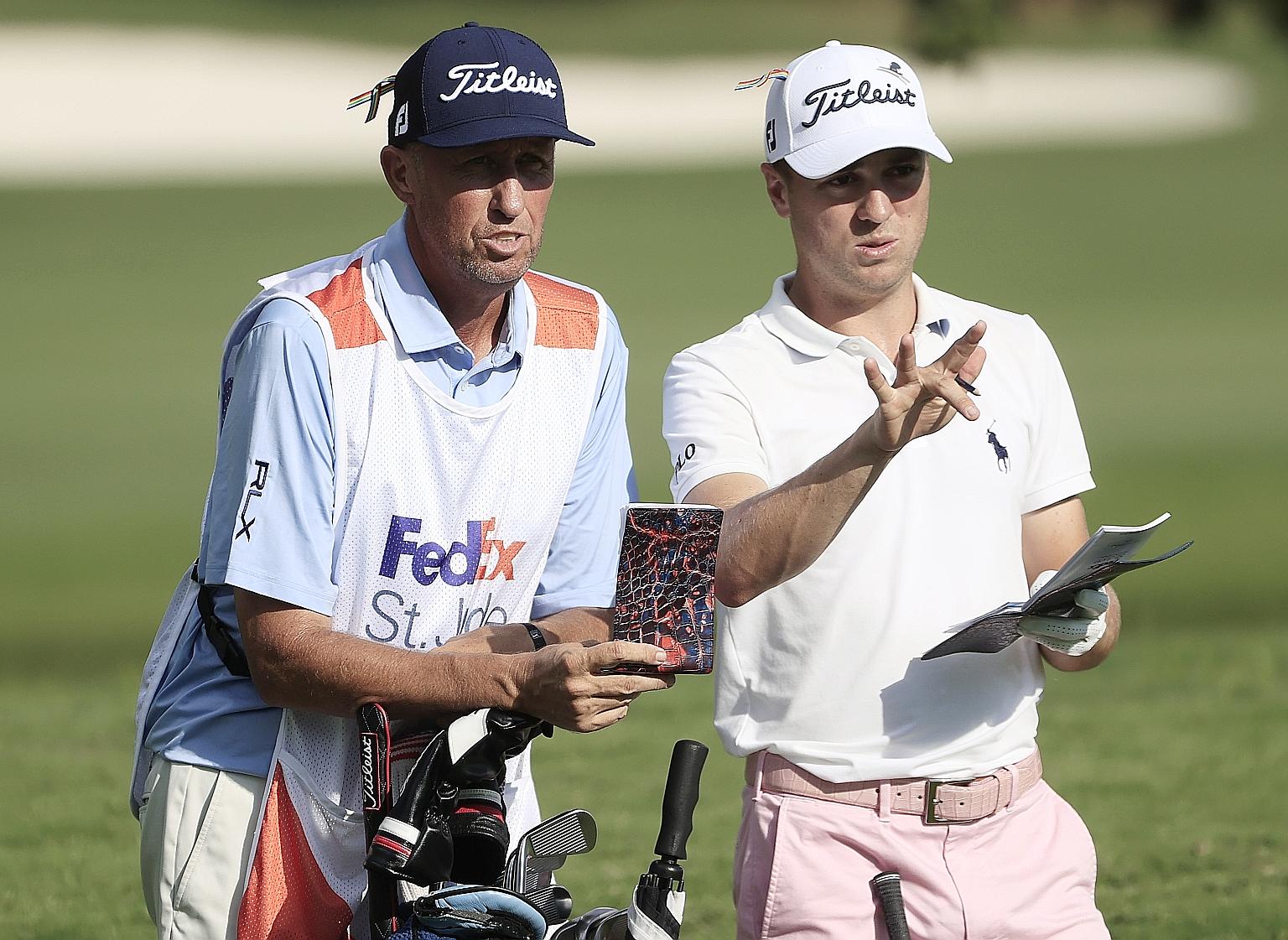 Justin Thomas and caddie Jim "Bones" Mackay discussing his second shot on the par-four final hole on Sunday. He saved par with a "pretty sick" chip for a three-shot win in the WGC event in Memphis.