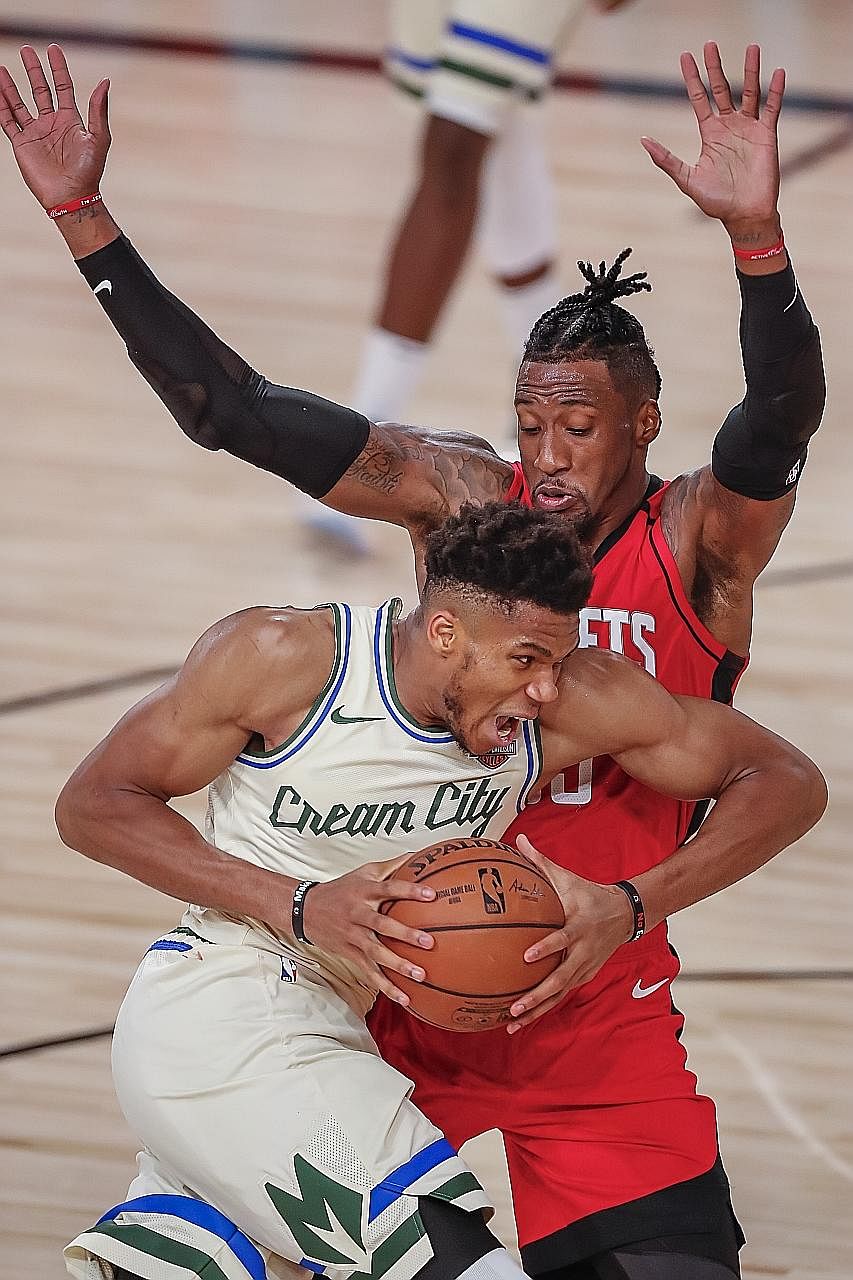 Milwaukee forward Giannis Antetokounmpo trying to get past Houston's Robert Covington during the Bucks' 120-116 loss in Florida. The Greek big man recorded game-high points (36), rebounds (18) and assists (eight).