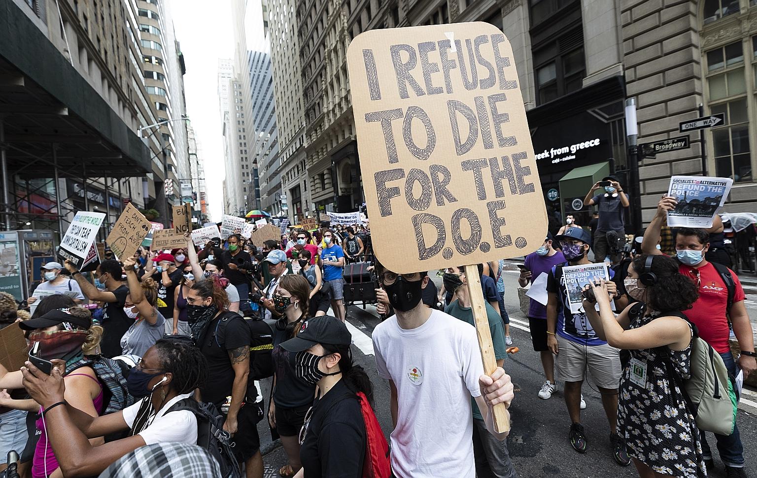 People at a protest on Monday in New York against plans to reopen schools in the midst of the coronavirus pandemic. The protest was part of a nationwide movement organised by teachers, students and parents. United States President Donald Trump has ma
