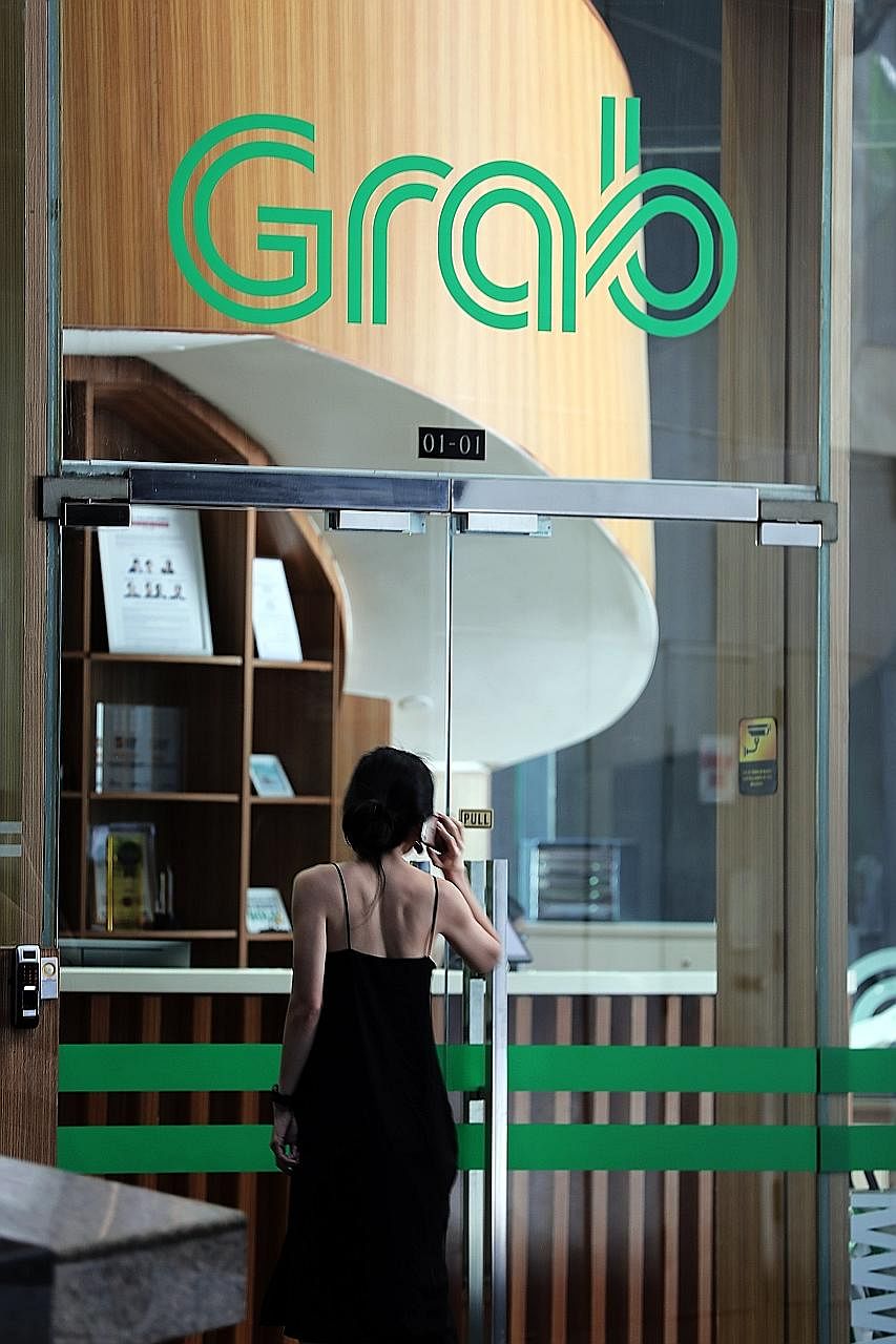 Grab's financial services arm is rolling out AutoInvest, which lets users invest sums as small as $1 while spending in Grab's ecosystem. ST PHOTO: KELVIN CHNG