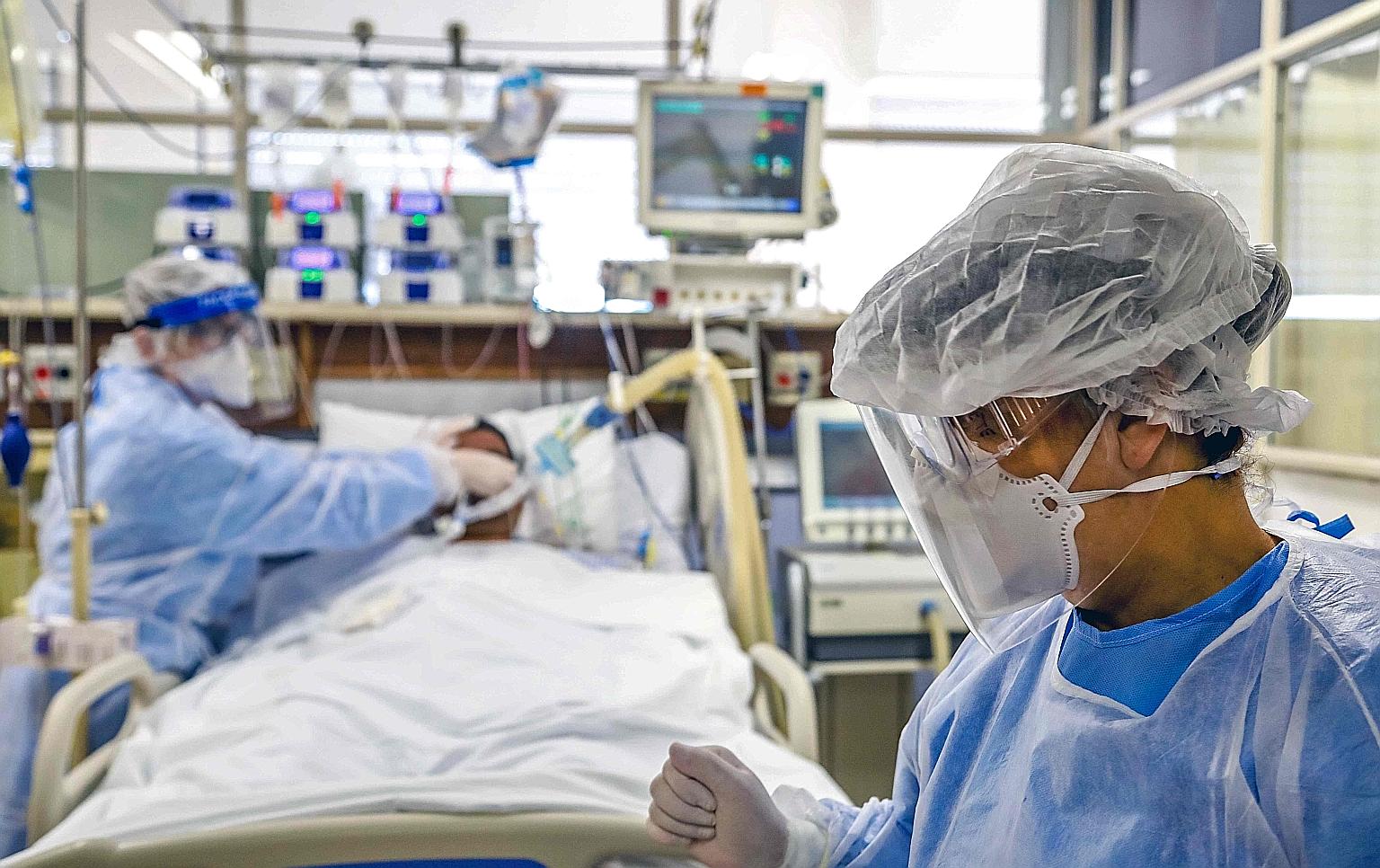 A Covid-19 patient in the intensive care unit at Hospital de Clinicas, in Porto Alegre, Brazil. The country is driving a surge in cases in Latin America and the Caribbean, where officials struggle to control the spread of the virus because of the reg
