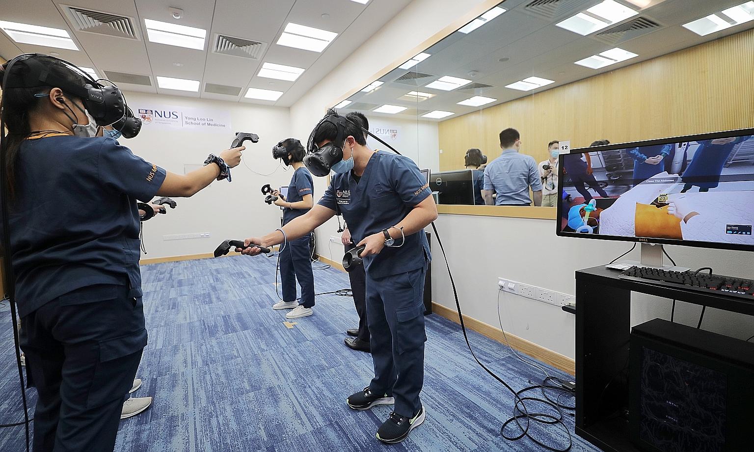 A group of third-year students at the NUS Yong Loo Lin School of Medicine learning in a virtual environment with the use of VR headsets and hand-held controllers. Their movements are observed by educators who guide them.