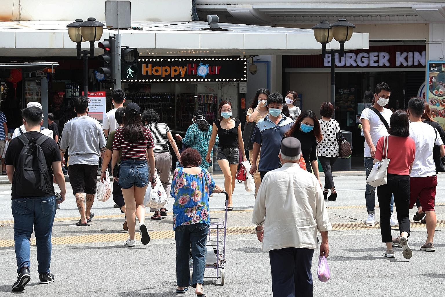 The lunch-time crowd in Bugis Street on Tuesday. More travellers are expected as Singapore gradually reopens its borders. The bustle near a bicycle rental shop in East Coast Park last Friday. Covid-19 task force co-chair Lawrence Wong said Singapore 