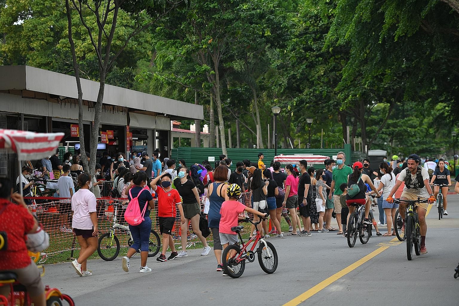 The lunch-time crowd in Bugis Street on Tuesday. More travellers are expected as Singapore gradually reopens its borders. The bustle near a bicycle rental shop in East Coast Park last Friday. Covid-19 task force co-chair Lawrence Wong said Singapore 