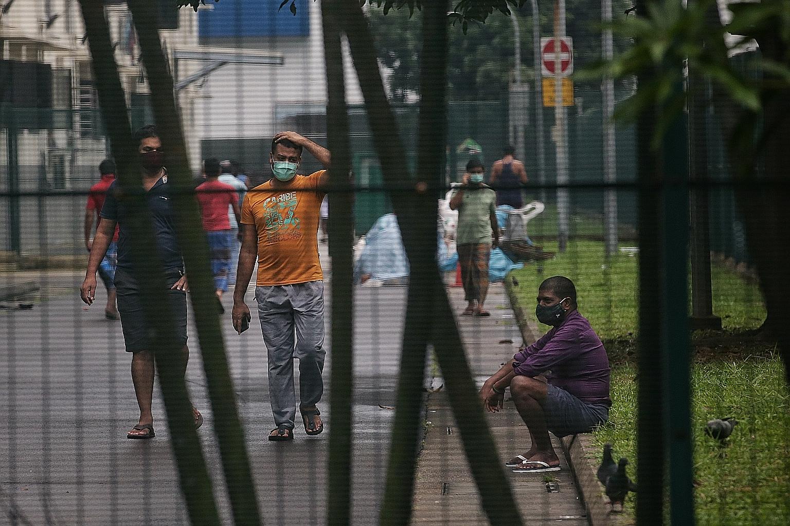 Foreign workers at a dormitory in Jurong last month. Employers have to provide dedicated transport between worksites and places of accommodation as part of enhanced safety measures. All workers living in dormitories will undergo Covid-19 tests every