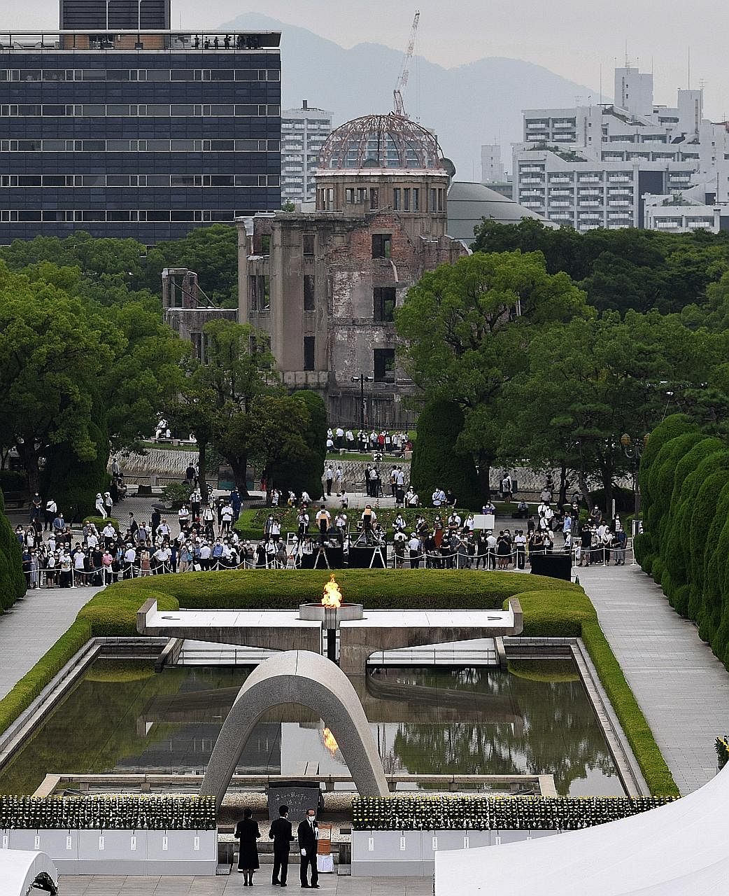 Though thousands usually pack Hiroshima's Peace Park on Aug 6 to pray and offer paper cranes as a symbol of peace, entry this year was limited and only survivors and their families could attend the memorial. PHOTOS: EPA-EFE An elderly woman (above) o