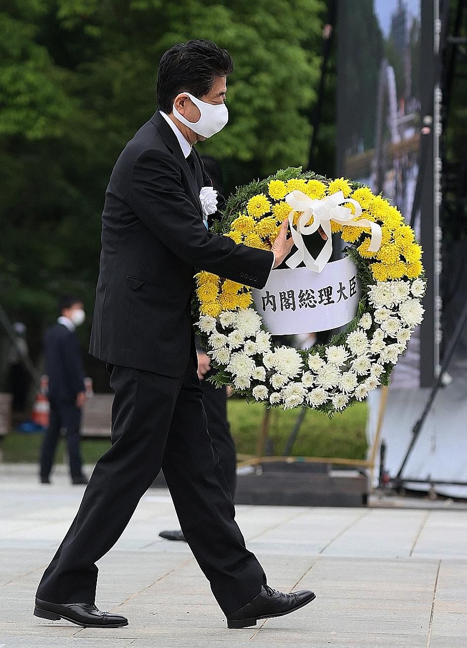 Though thousands usually pack Hiroshima's Peace Park on Aug 6 to pray and offer paper cranes as a symbol of peace, entry this year was limited and only survivors and their families could attend the memorial. PHOTOS: EPA-EFE An elderly woman (above) o