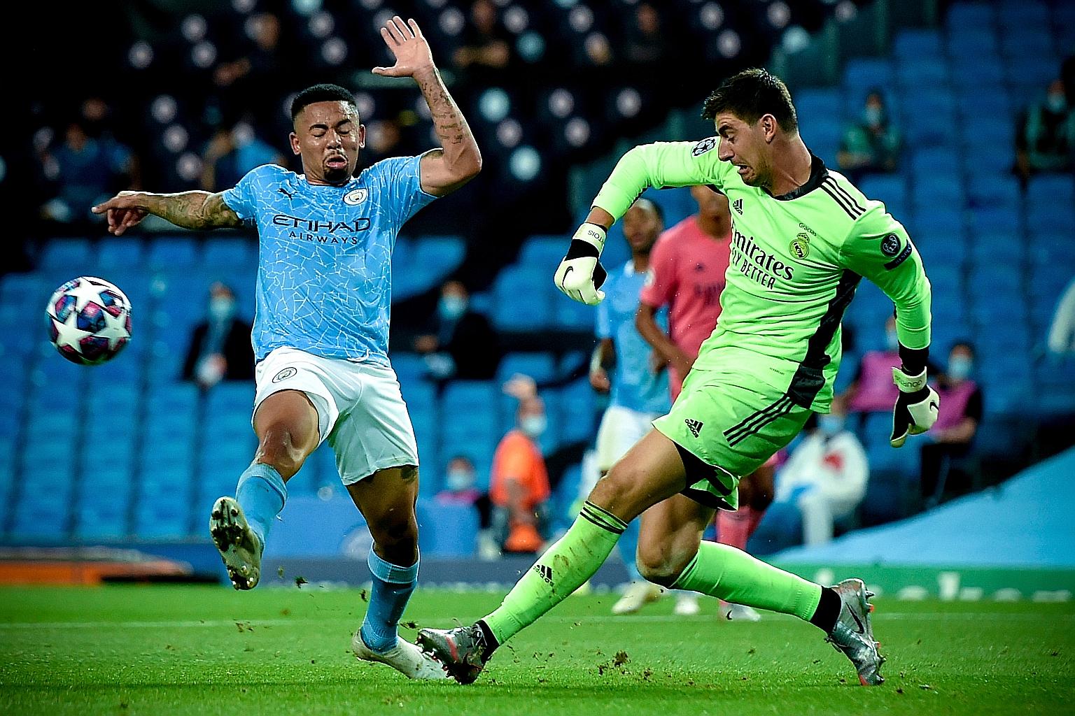 Real Madrid's goalkeeper Thibaut Courtois clearing the ball in time from Manchester City's Gabriel Jesus in their Champions League round-of-16 second leg at the Etihad Stadium on Friday. But Courtois could not stop two strikes by Jesus and Raheem Ste