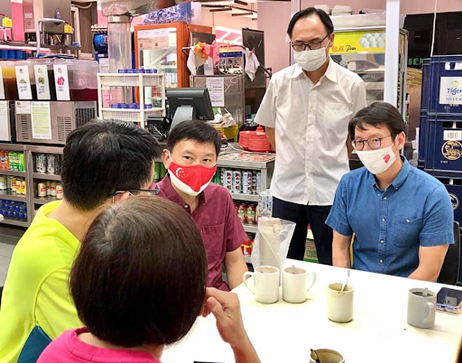 Senior Minister of State for Transport Chee Hong Tat (in red shirt) and MPs (from right) Edward Chia and Liang Eng Hwa meeting residents yesterday to hear their concerns about the bus route changes. PHOTO: EDWARD CHIA/FACEBOOK